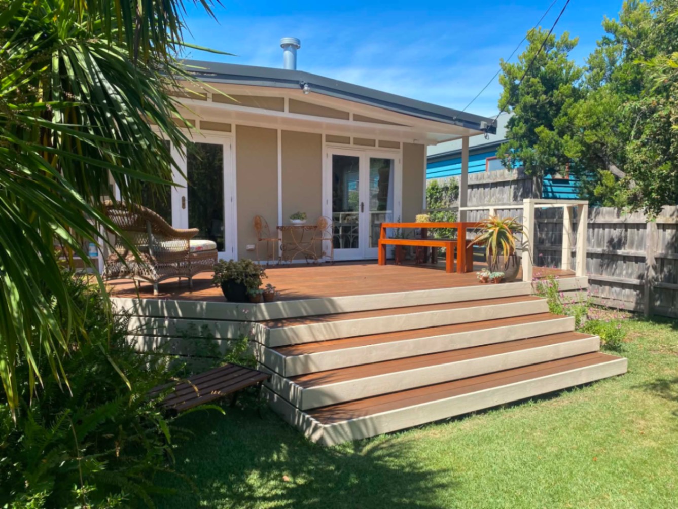 Rear deck with wraparound steps and lounge chair